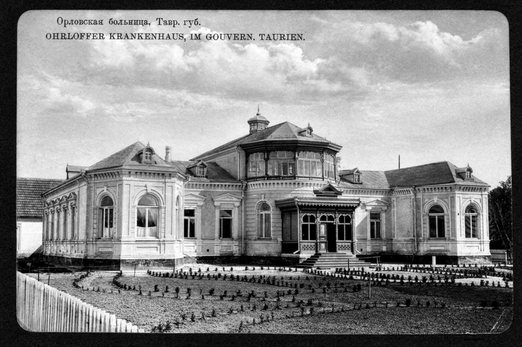 An image of the Ohrloff Hospital, which features a two story building made with brick and large windows.